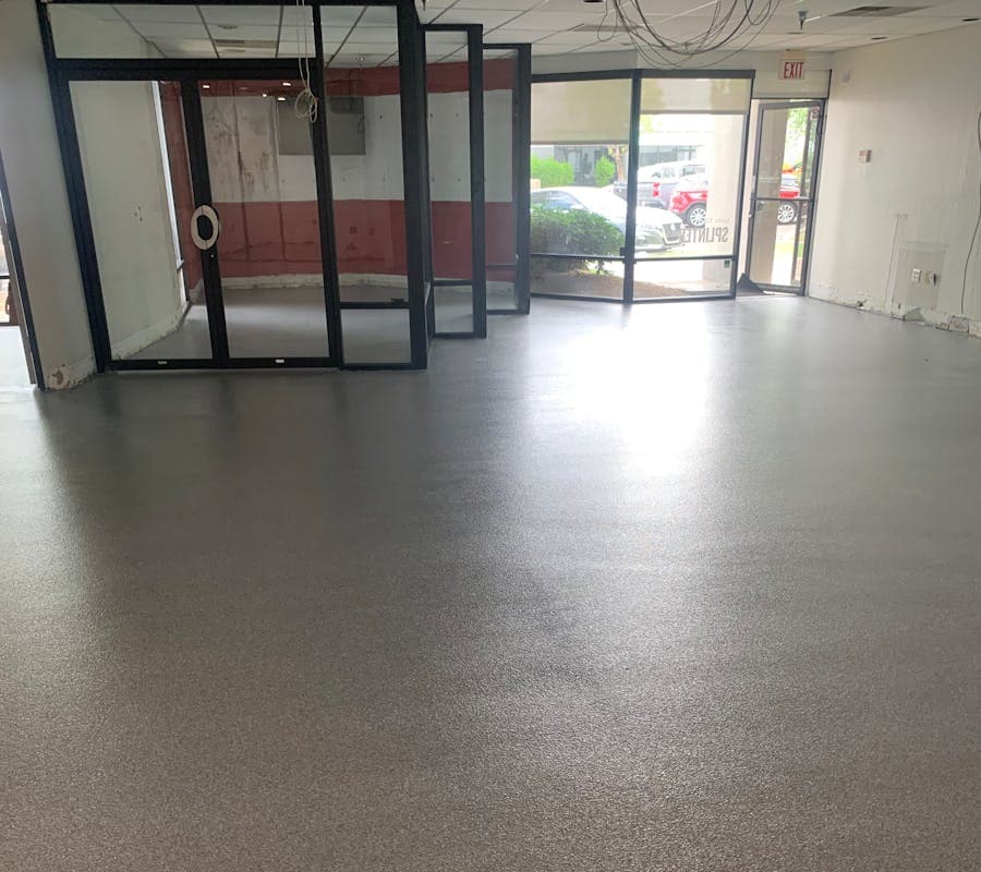 Seamless gray flake polyaspartic coating in a finished Arizona garage
