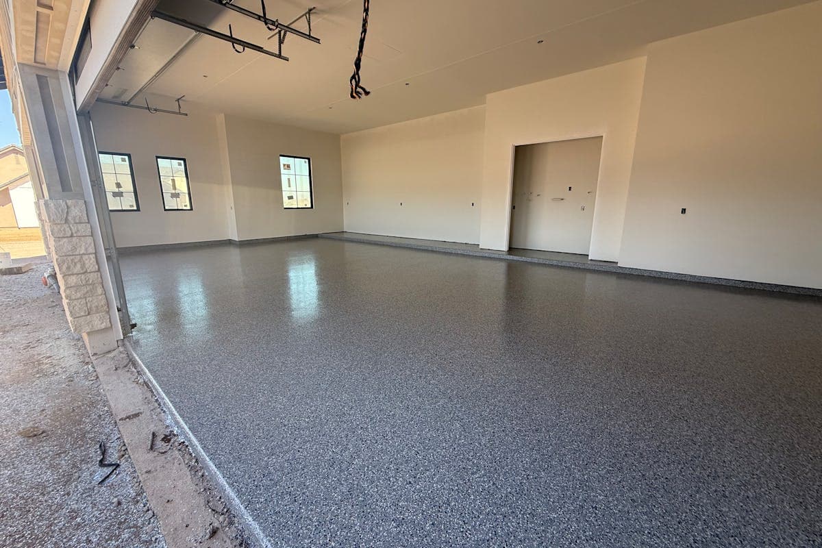Freshly installed flake polyaspartic garage floor in a new Arizona home